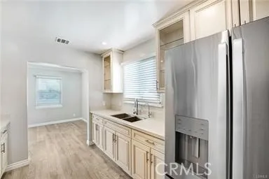 a kitchen with stainless steel appliances granite countertop a refrigerator a sink and a stove