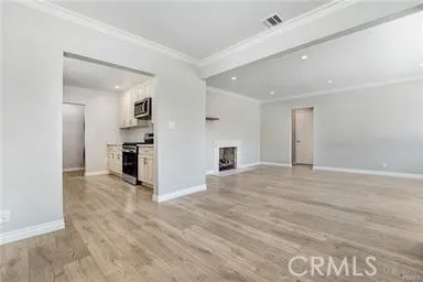 a kitchen with granite countertop white cabinets and stainless steel appliances