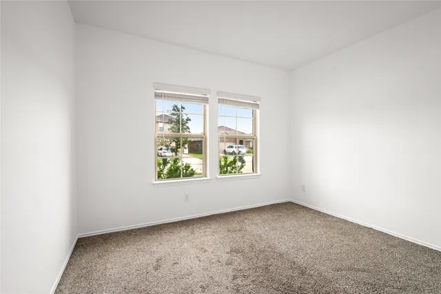 a bathroom with a bathtub shower sink mirror and toilet