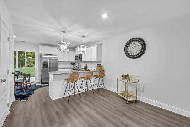 a view of a dining room with furniture and wooden floor