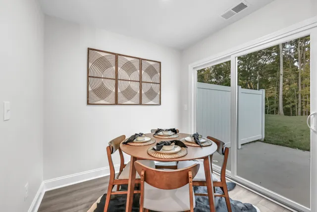 a dining room with furniture and window