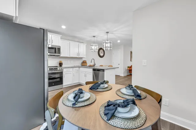 a kitchen with a table and chairs in it