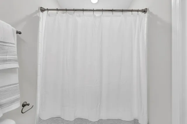 a bathroom with a shower curtain and toilet