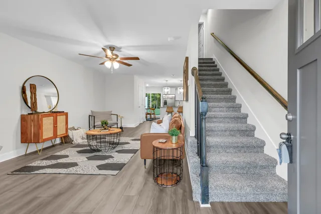 a living room with furniture and wooden floor