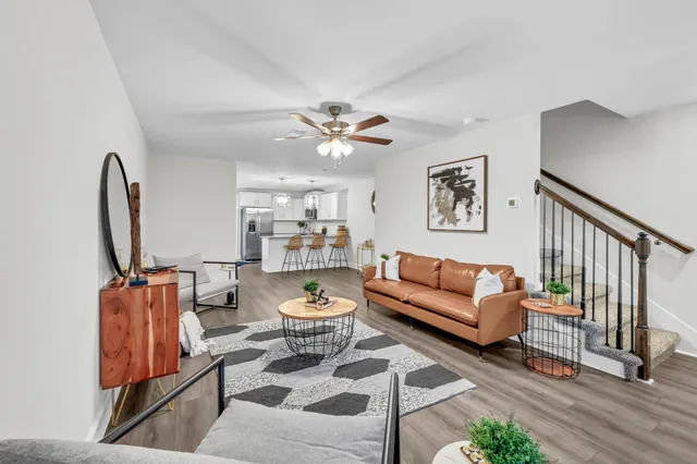 a living room with furniture a rug and a chandelier