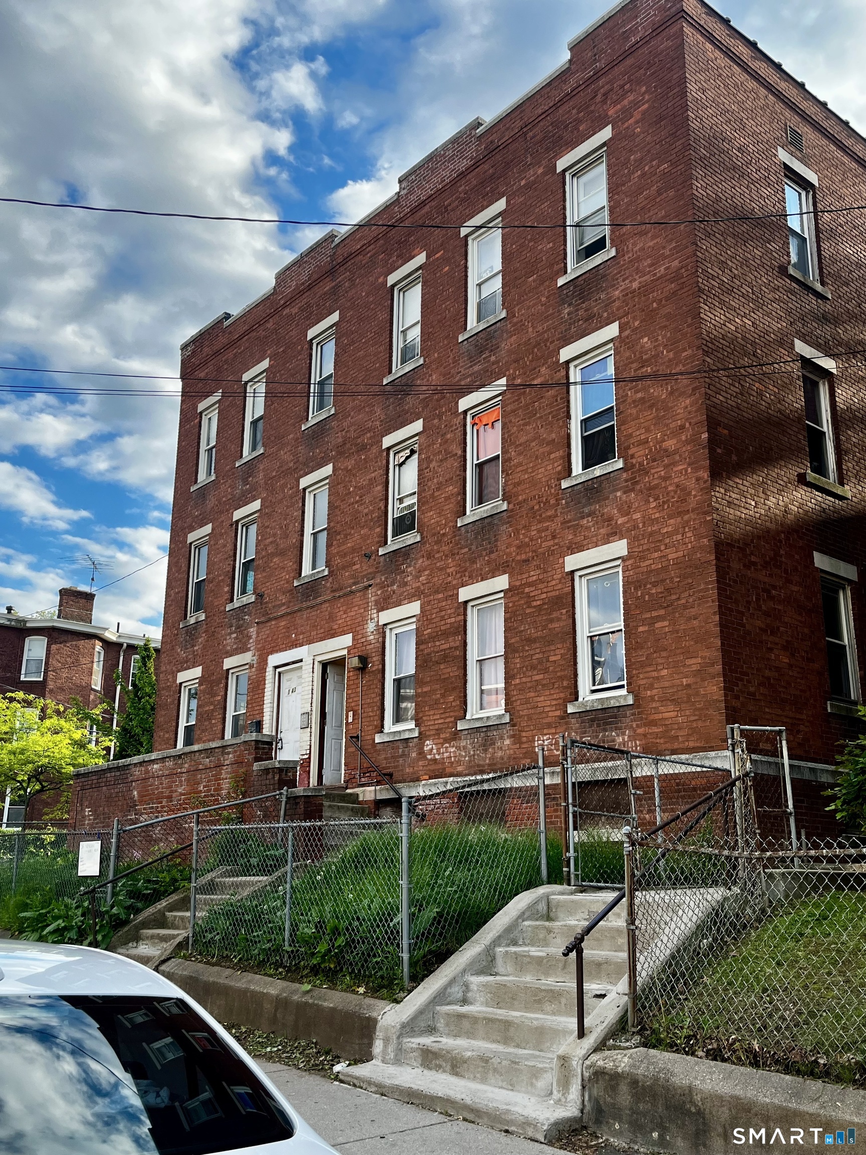 a front view of a building with garden