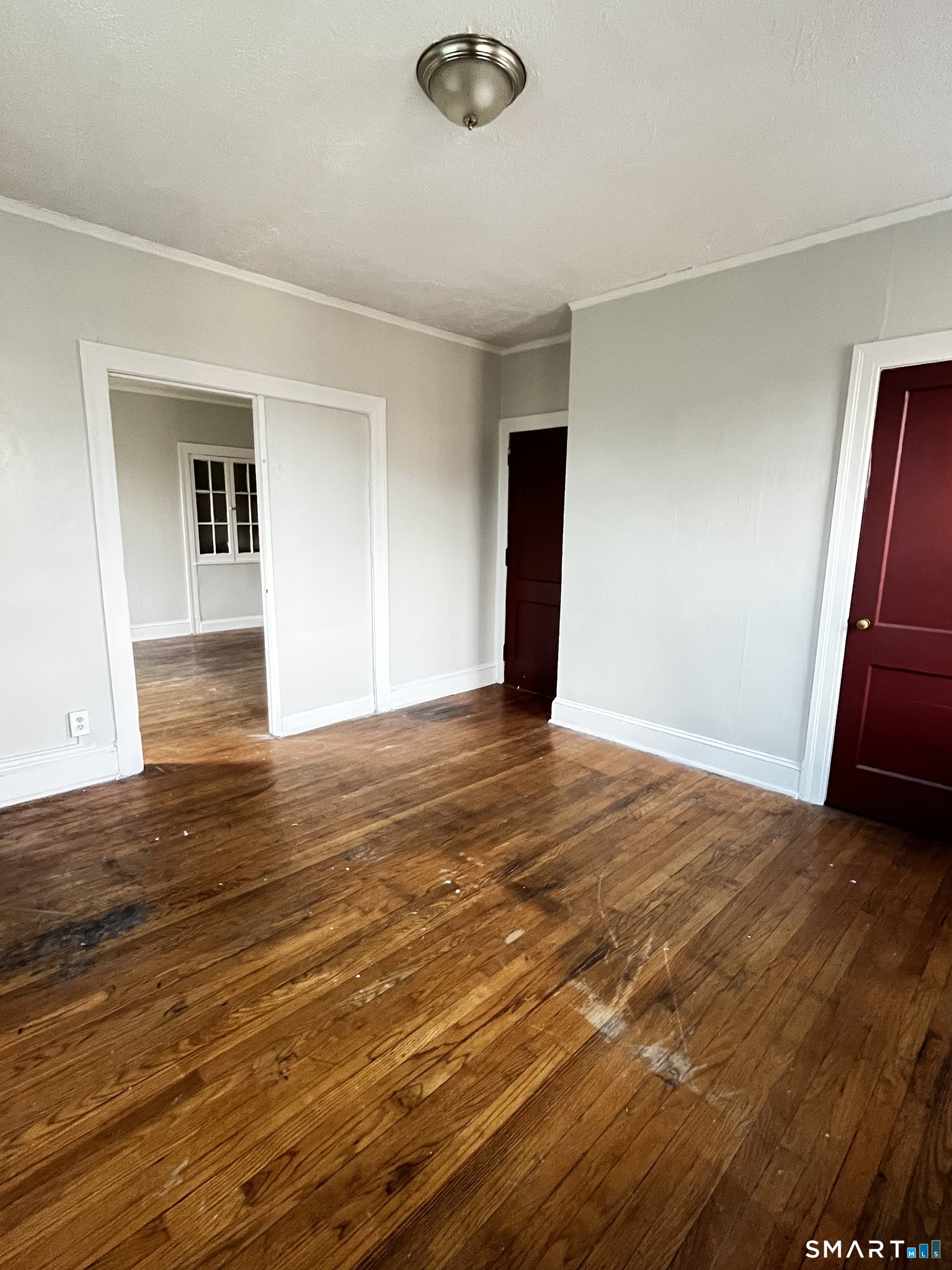 143 Putnam Street, Unit 2S Hartford, CT 06106 - Photo 4 of 9 a view of an empty room with wooden floor