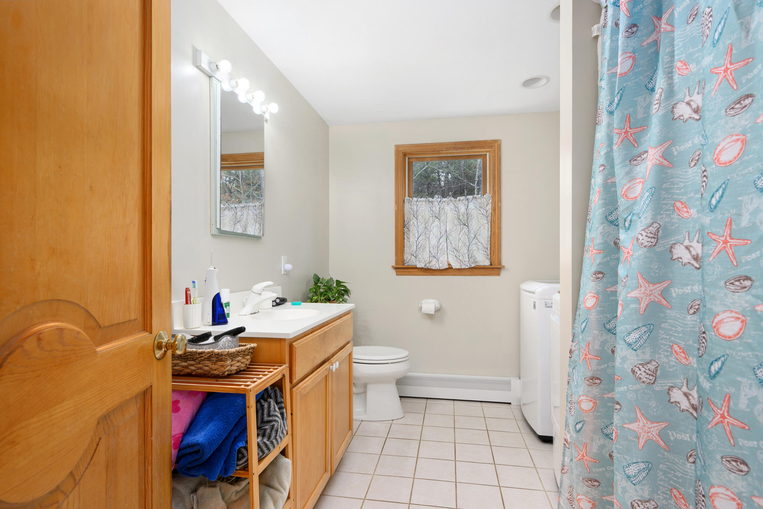 2 Short Lots Lane Truro, MA 02666 - Photo 16 of 66 a bathroom with a sink mirror vanity and toilet