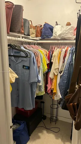 a view of walk in closet with clothes