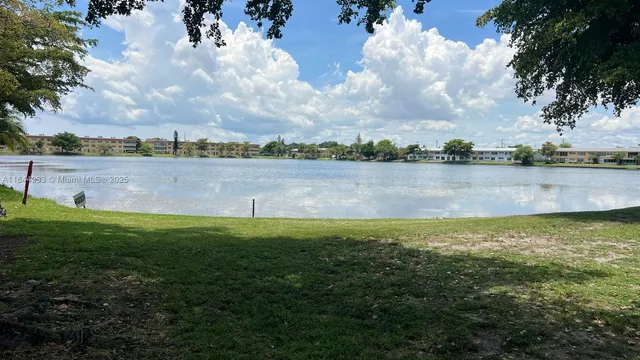 a view of a lake with houses in the back