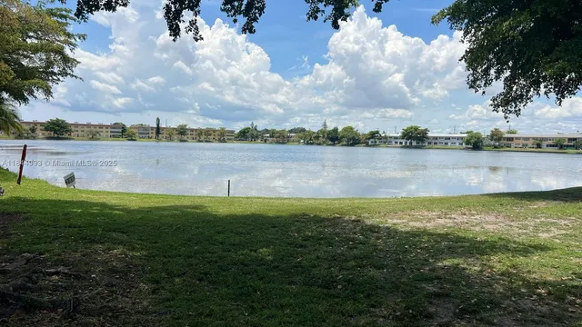 a view of a lake with houses in the back
