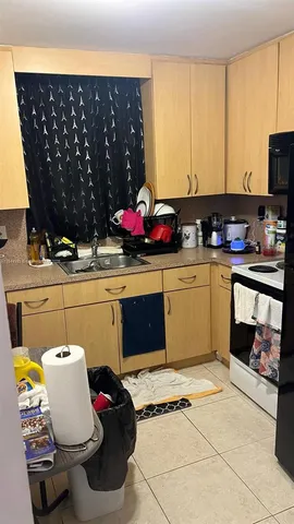a kitchen with a sink cabinets and appliances