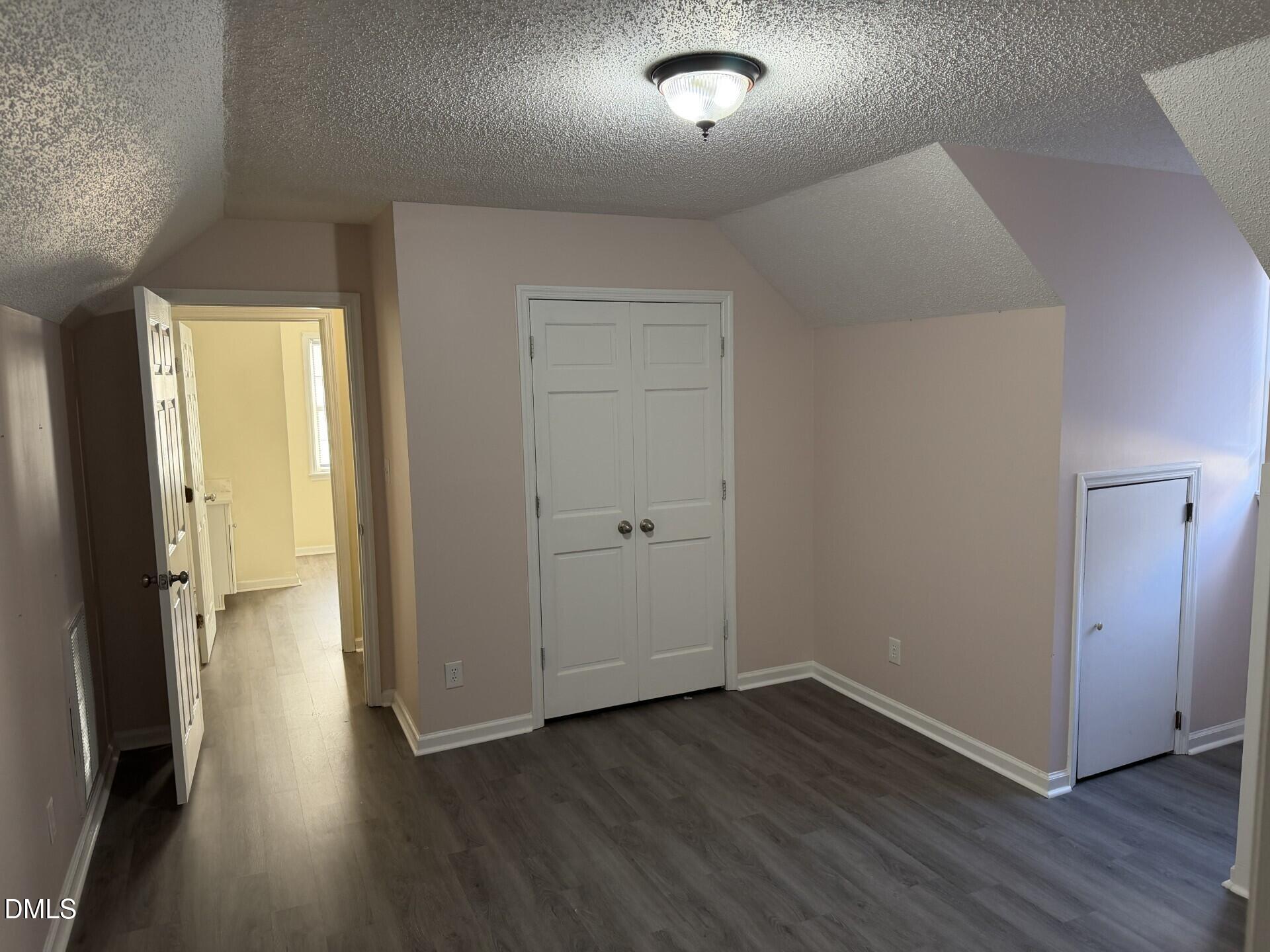 210 South Maple Avenue Kenly, NC 27542 - Photo 11 of 12 an empty room with wooden floor and a window