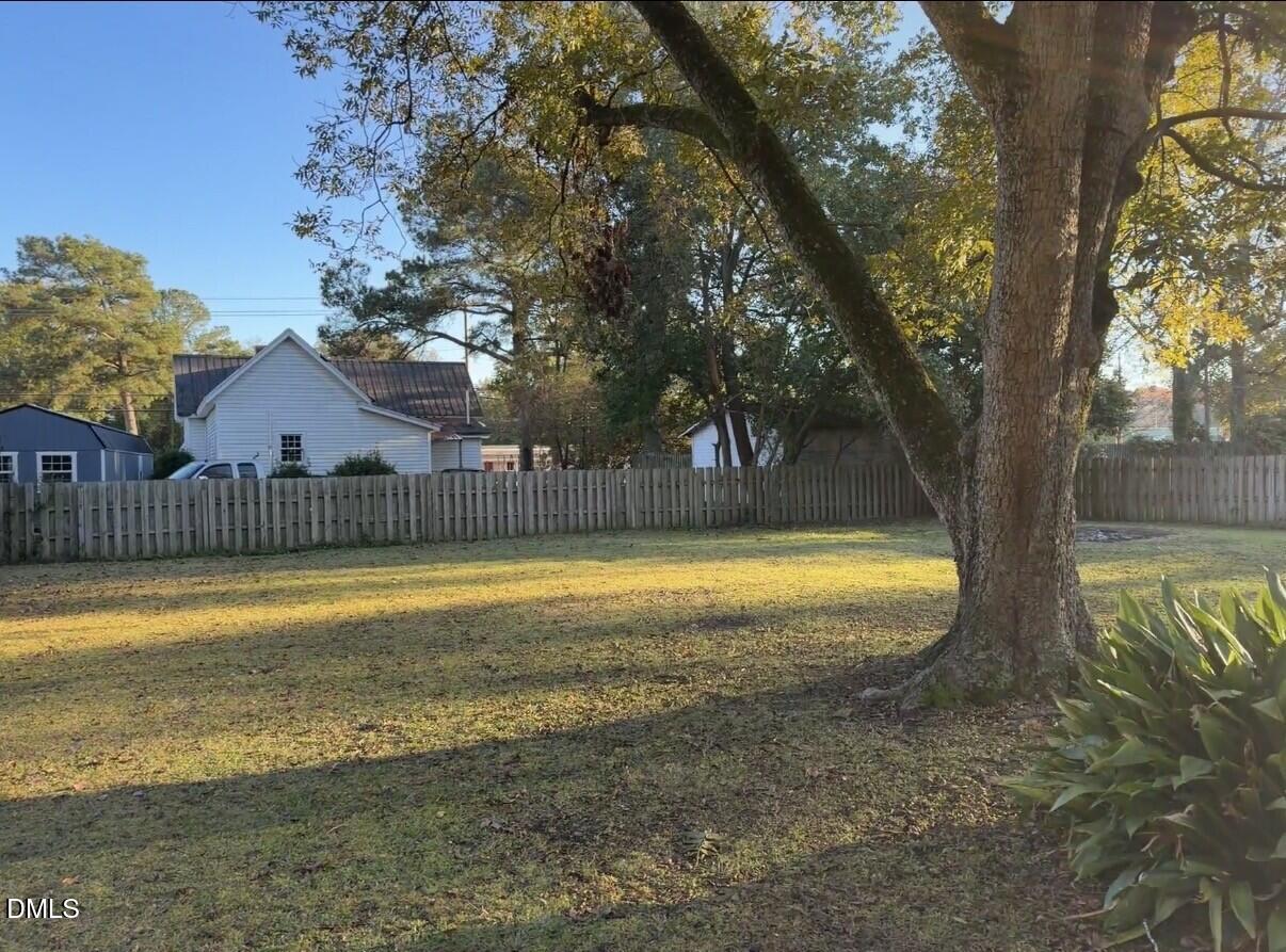 210 South Maple Avenue Kenly, NC 27542 - Photo 12 of 12 a view of swimming pool with table and wooden fence