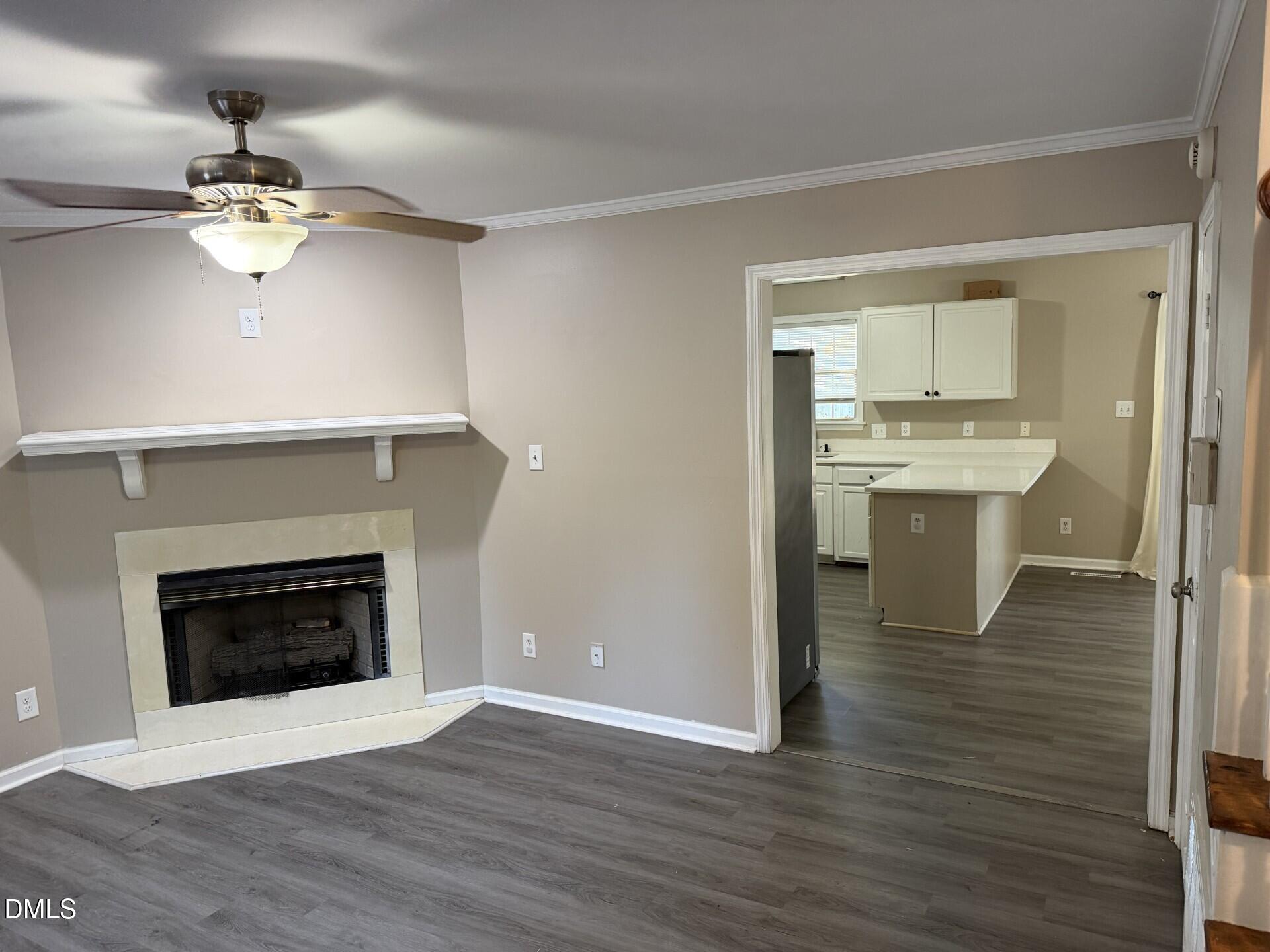 210 South Maple Avenue Kenly, NC 27542 - Photo 4 of 12 a view of a kitchen with a sink a fireplace and wooden floor