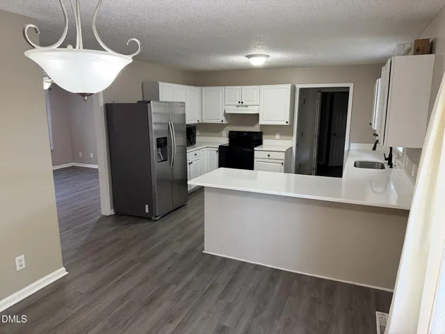 a kitchen with stainless steel appliances a refrigerator and a sink