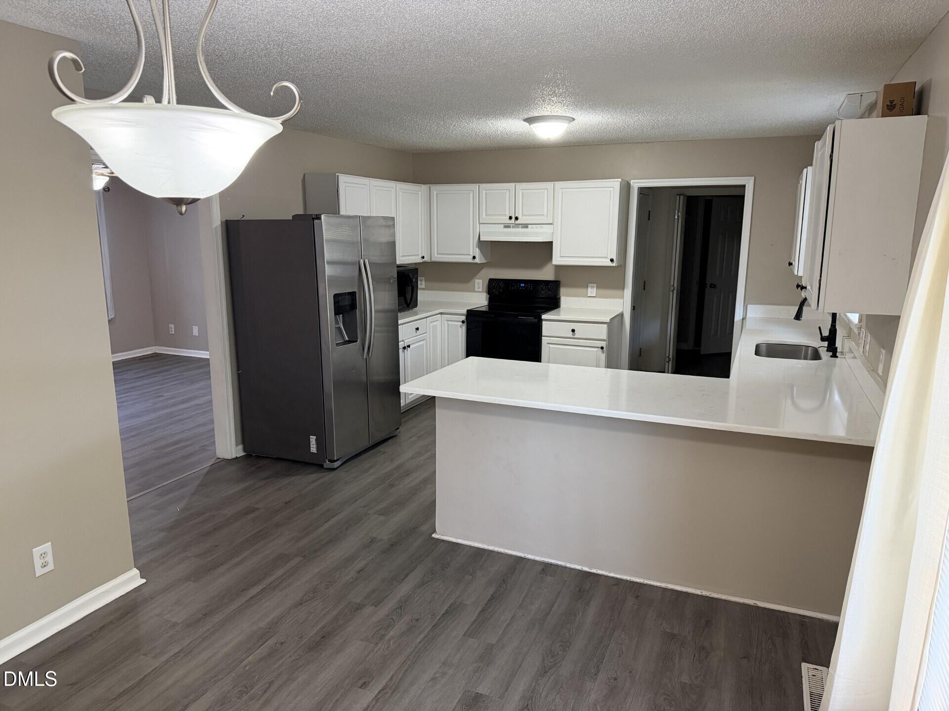 210 South Maple Avenue Kenly, NC 27542 - Photo 5 of 12 a kitchen with stainless steel appliances a refrigerator and a sink