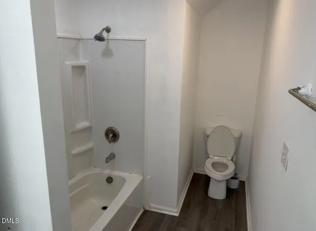 a bathroom with a bathtub and toilet
