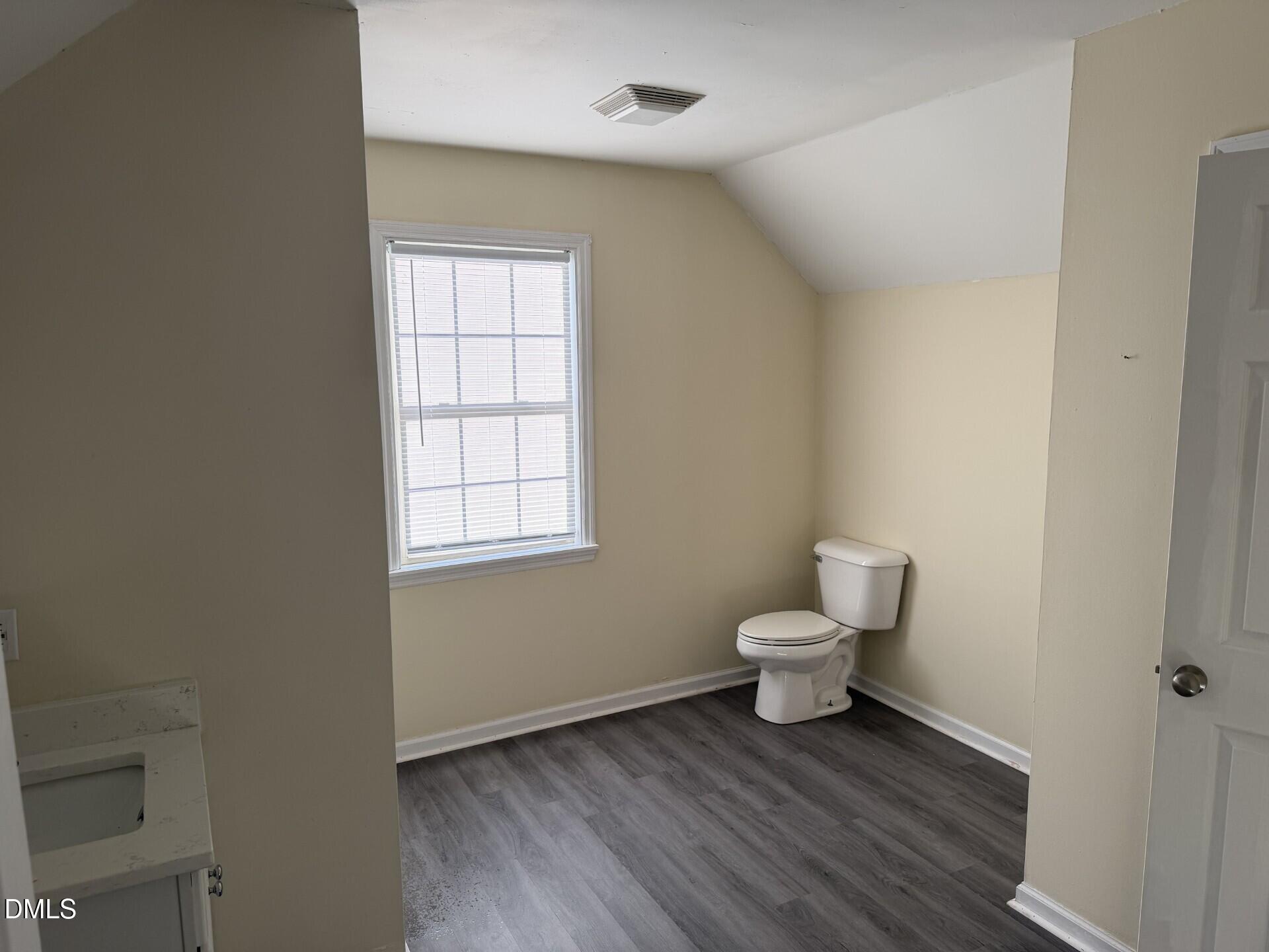 210 South Maple Avenue Kenly, NC 27542 - Photo 10 of 12 a bathroom with a toilet a sink and a window