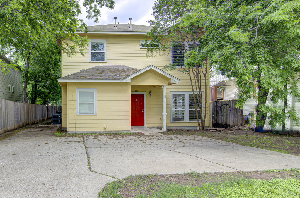 1702 Singleton Avenue, Unit A Austin, TX 78702 - Photo 1 of 27 a front view of a house with a yard and garage
