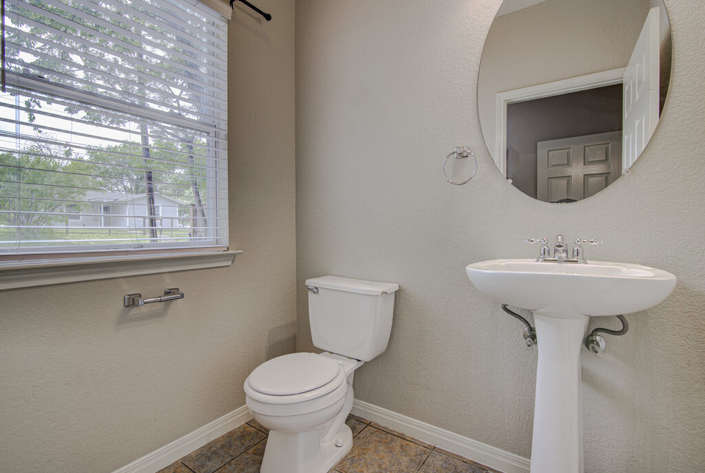 1702 Singleton Avenue, Unit A Austin, TX 78702 - Photo 11 of 27 a bathroom with a toilet sink and mirror