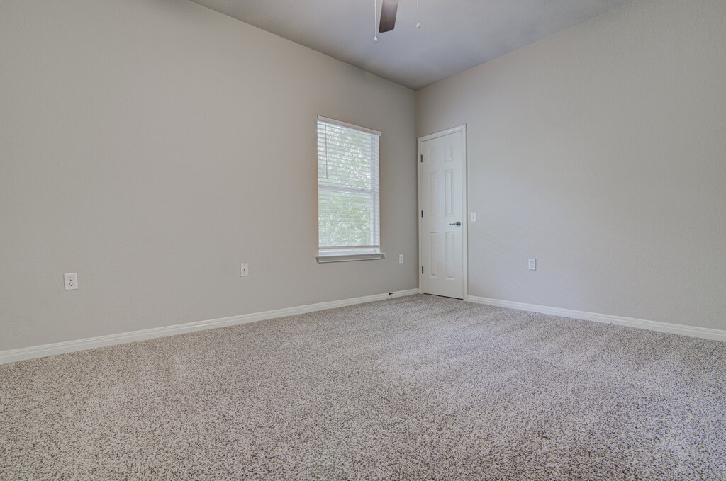 1702 Singleton Avenue, Unit A Austin, TX 78702 - Photo 12 of 27 an empty room with windows and closet