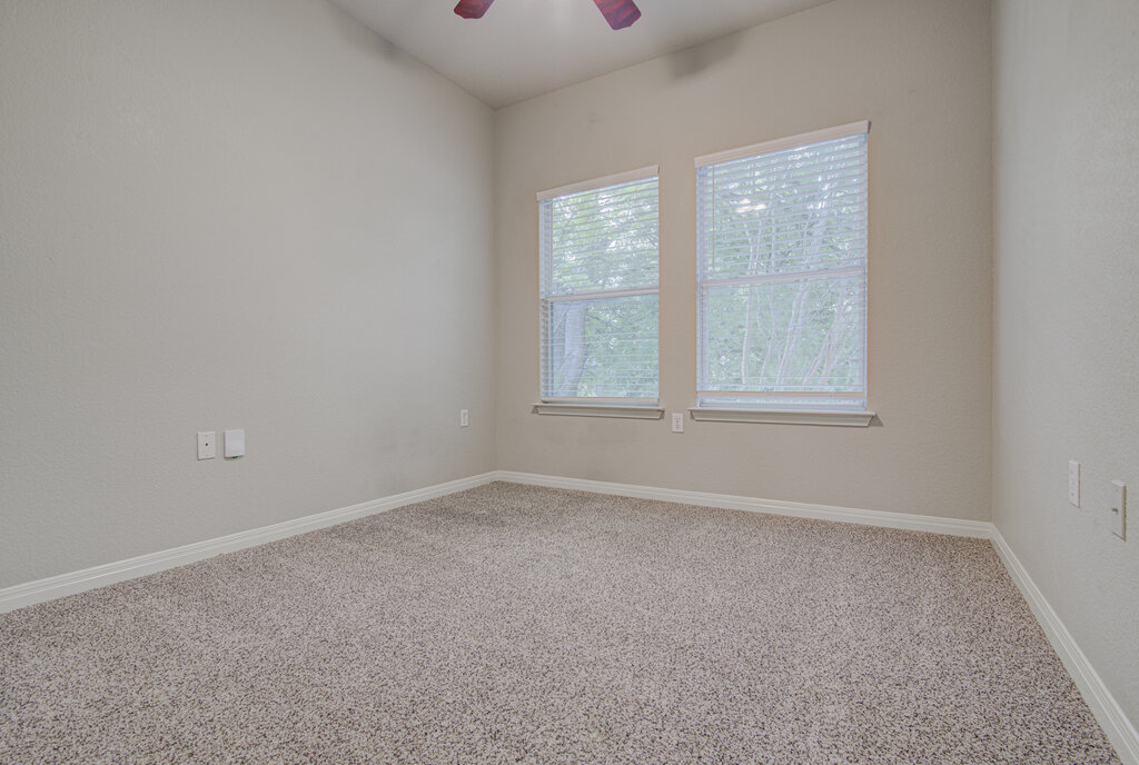 1702 Singleton Avenue, Unit A Austin, TX 78702 - Photo 19 of 27 an empty room with windows and closet