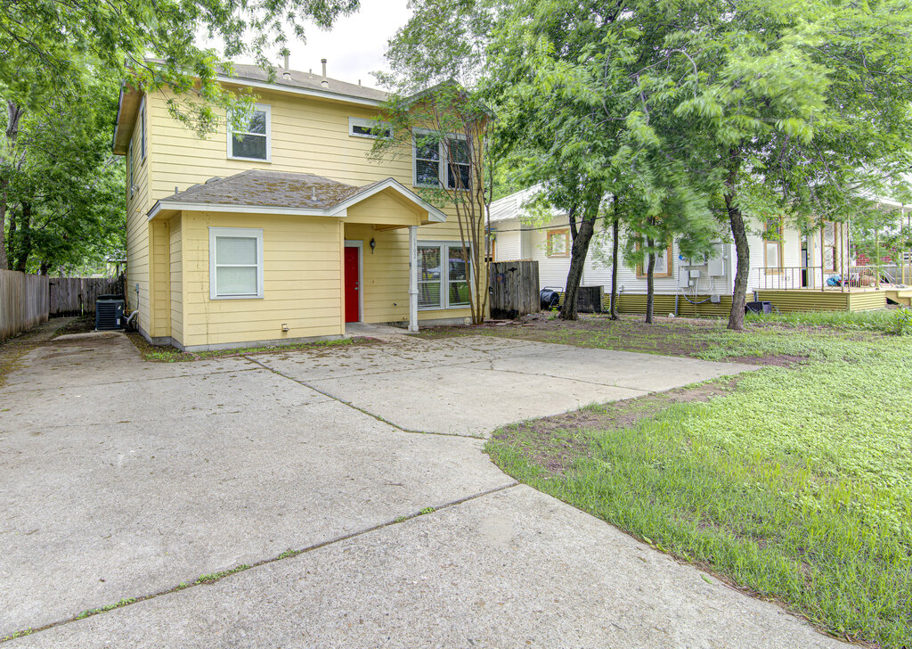1702 Singleton Avenue, Unit A Austin, TX 78702 - Photo 2 of 27 a front view of a house with a yard and garage