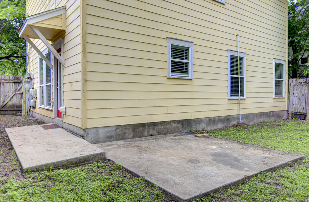 1702 Singleton Avenue, Unit A Austin, TX 78702 - Photo 27 of 27 a view of a backyard with pathway and a building