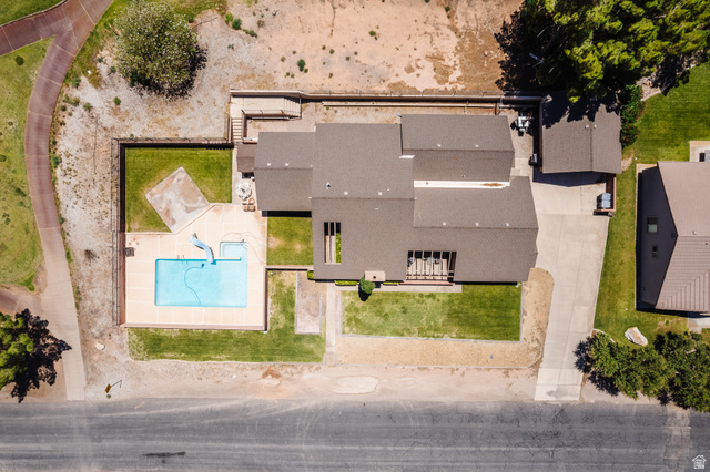 1470 Redwood Tree Street St. George, UT 84790 - Photo 41 of 53 Expansive property featuring a rectangular pool with surrounding patio, a concrete driveway, and a detached structure