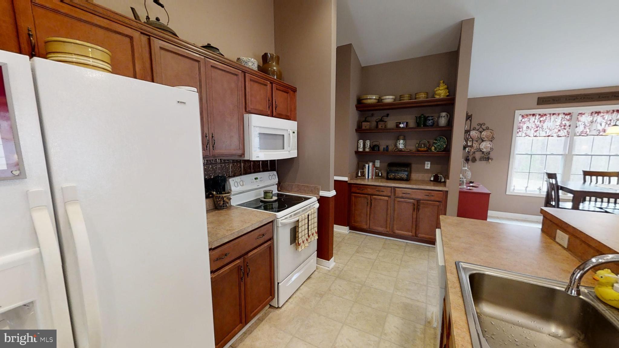 839 Daniel Road Louisa, VA 23093 - Photo 8 of 31 a kitchen with stainless steel appliances granite countertop a stove a sink and a refrigerator