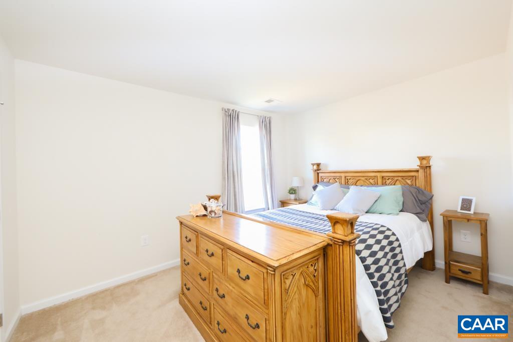 309 Ridgemont Road Ruckersville, VA 22968 - Photo 17 of 29 a bedroom with a bed and a chair