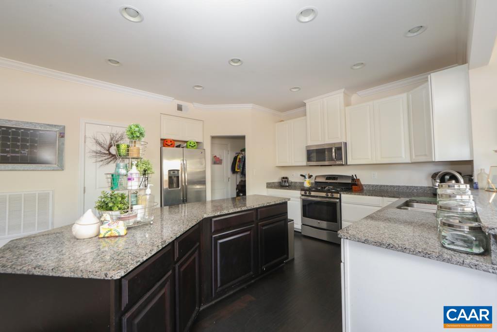 309 Ridgemont Road Ruckersville, VA 22968 - Photo 4 of 29 a kitchen with kitchen island granite countertop stainless steel appliances a sink a stove top oven a counter space and cabinets