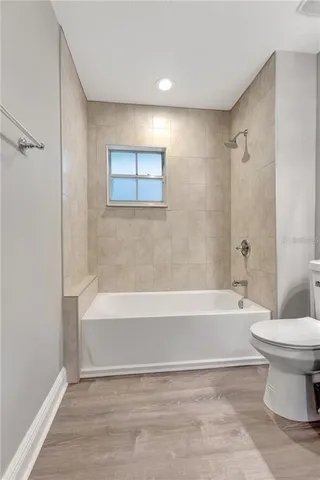 a bathroom with a bathtub and a toilet