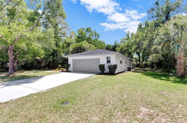a front view of house with yard and trees