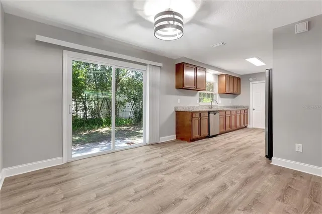 a view of kitchen with furniture wooden floor and window