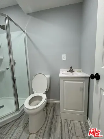 a white toilet sitting next to a sink
