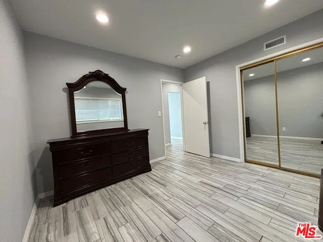 a room with a dresser and a mirror