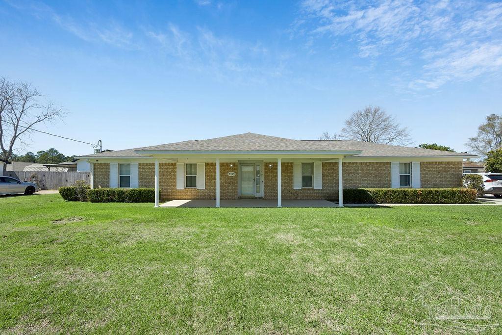 a front view of a house with a garden