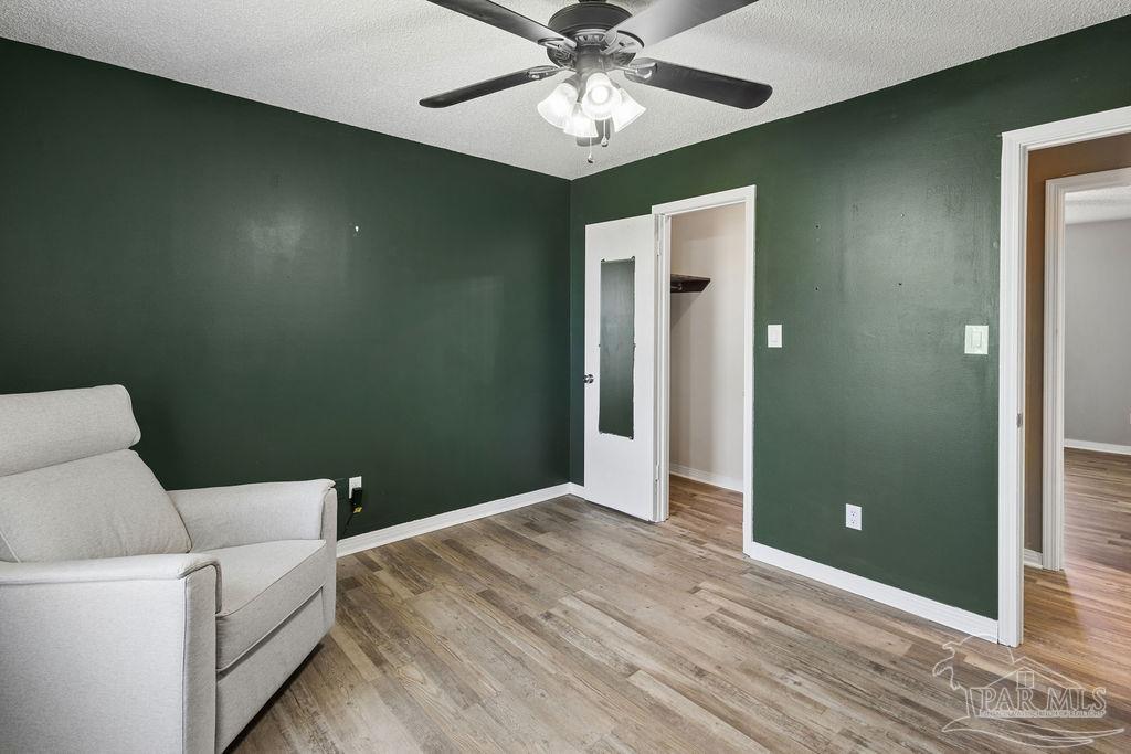 2329 Ryale Road Cantonment, FL 32533 - Photo 11 of 31 a workspace with wooden floor and chandelier fan