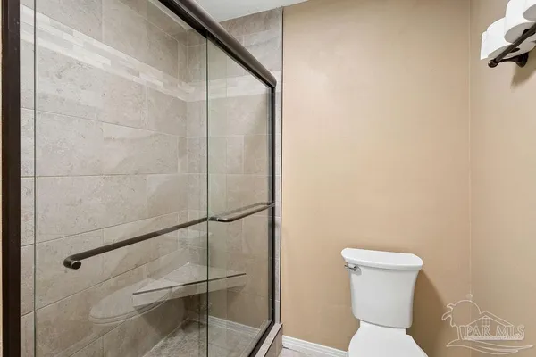 a bathroom with a toilet and a shower