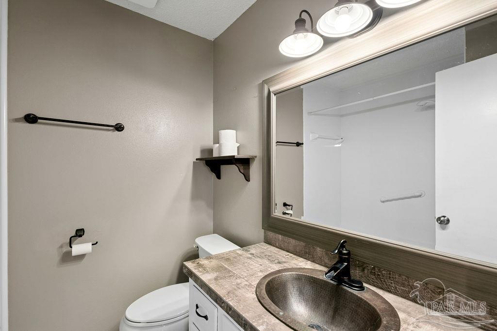 2329 Ryale Road Cantonment, FL 32533 - Photo 16 of 31 a bathroom with a sink a toilet and a mirror
