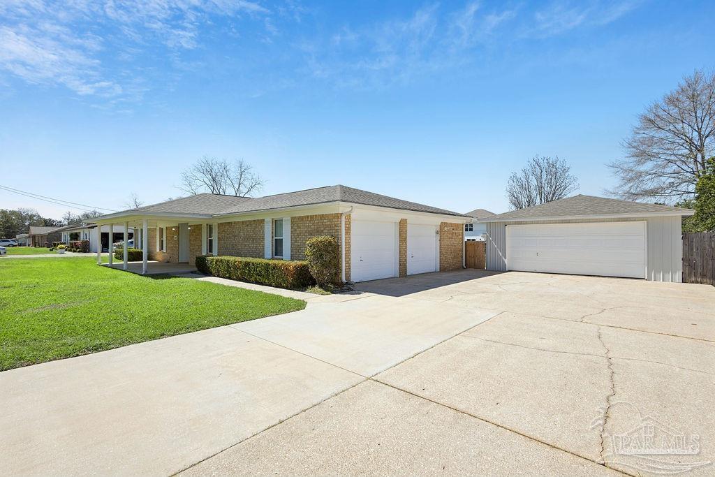 2329 Ryale Road Cantonment, FL 32533 - Photo 2 of 31 a front view of house with garage and yard