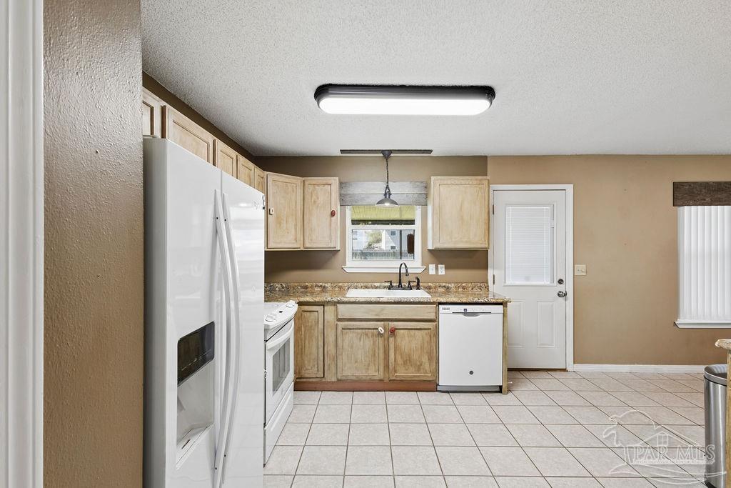 2329 Ryale Road Cantonment, FL 32533 - Photo 21 of 31 a kitchen with white cabinets and white appliances