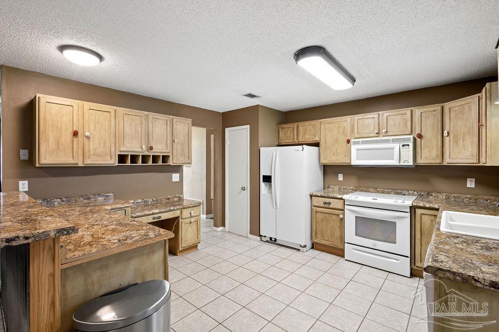 2329 Ryale Road Cantonment, FL 32533 - Photo 4 of 31 a kitchen with a sink stove and refrigerator