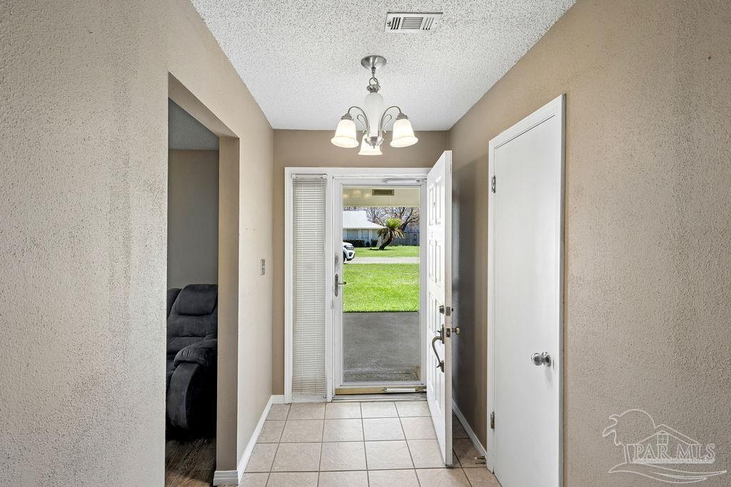2329 Ryale Road Cantonment, FL 32533 - Photo 9 of 31 a view of a hallway view with wooden floor and a livingroom with furniture