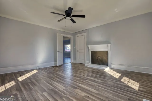 wooden floor in an empty room with a fireplace