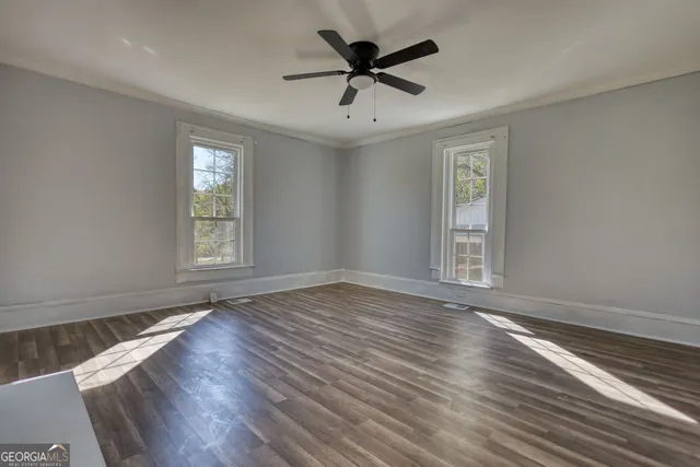 wooden floor in an empty room with a window