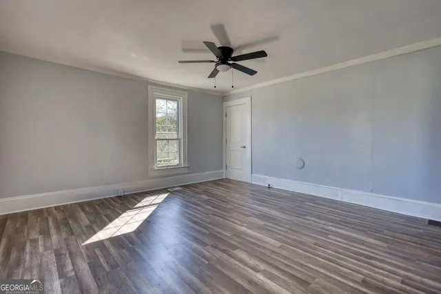 wooden floor in an empty room with a window