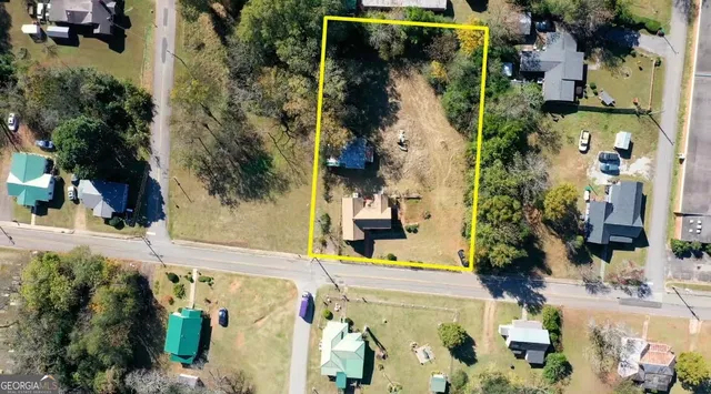 an aerial view of a house with a yard